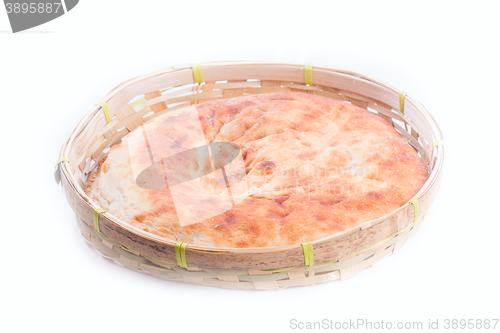 Image of pita in wicker bread bin on white background