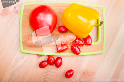 Image of tomato paprika carrot on wooden board