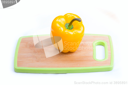 Image of yellow  paprika on wooden board