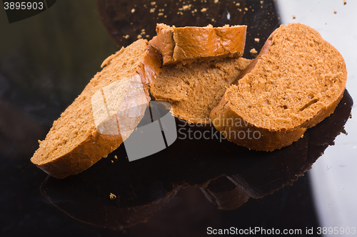 Image of sliced bread on dark glass background