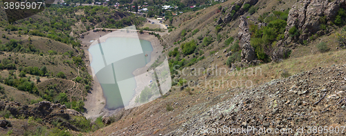 Image of Dried out reservoir glistens silver in sun at noon panorama