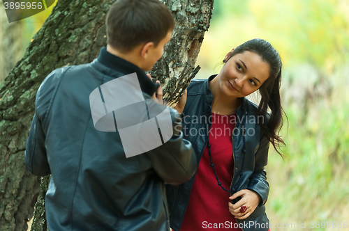 Image of Affectionate couple taking walk in autumn park