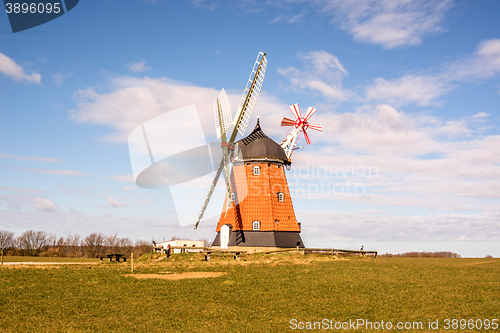 Image of Old mill on a green meadow