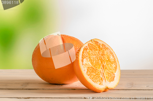 Image of Orange fruit on a wooden outdoor table