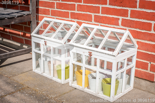 Image of Small outdoors greenhouse in white colors