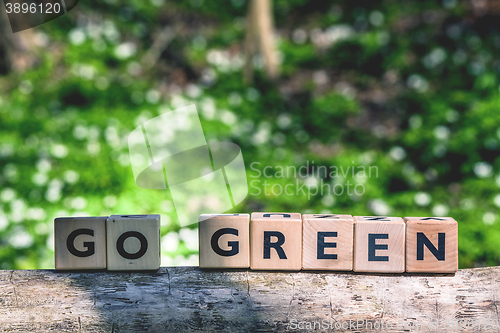 Image of Go green message in a forest