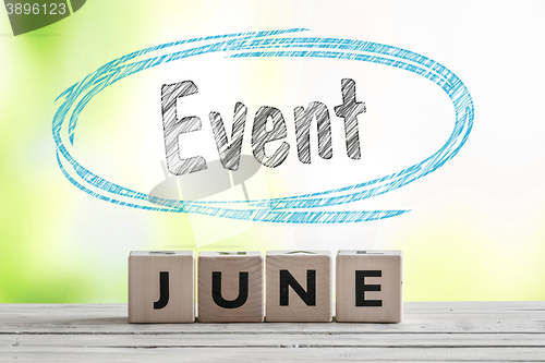 Image of June event sign on a wooden stage