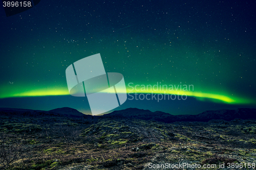 Image of Northern lights over distant mountains