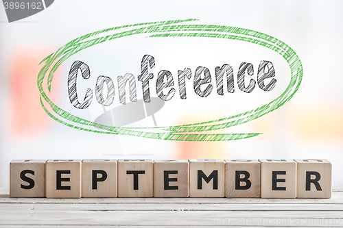 Image of September conference sign with green sketch