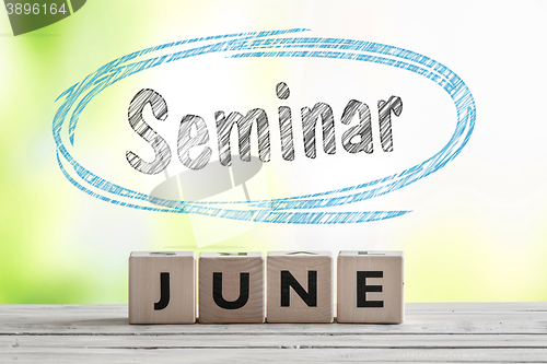 Image of June seminar sign on a wooden stage