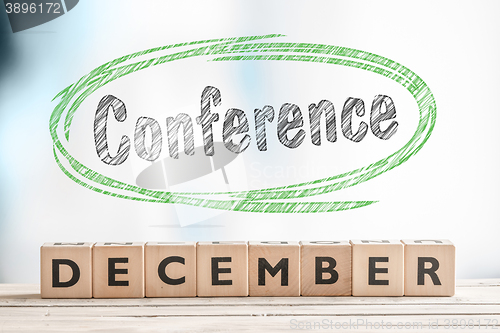 Image of December conference sign on a stage