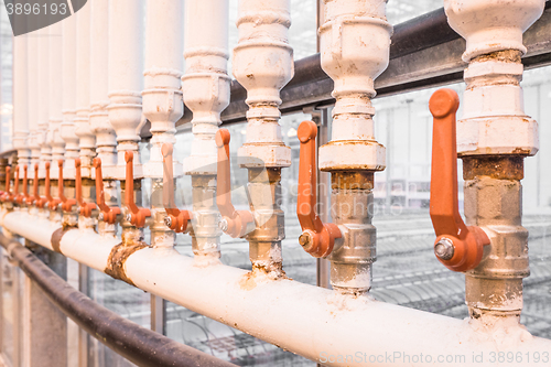 Image of Orange handles on white pipes