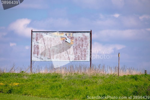 Image of billboard with old torn posters