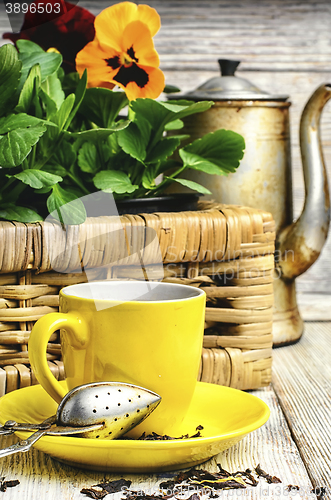 Image of tea and flower pansy