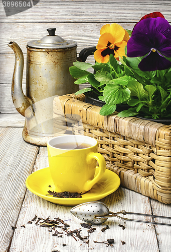 Image of tea and flower pansy