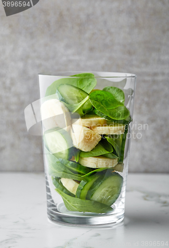 Image of glass of green smoothie ingredients