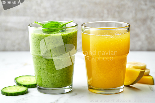 Image of smoothie and juice glasses on gray kitchen table