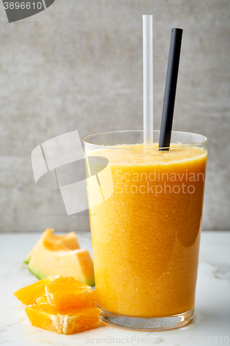 Image of glass of orange and melon smoothie