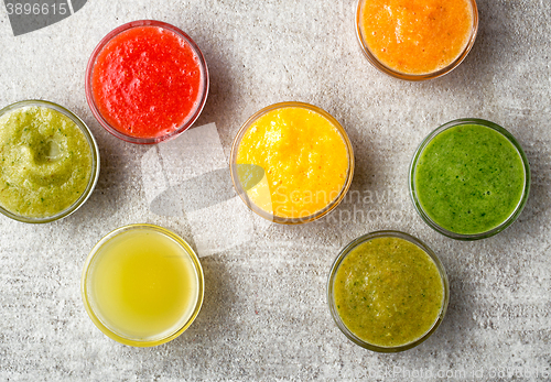 Image of various smoothies on gray kitchen table