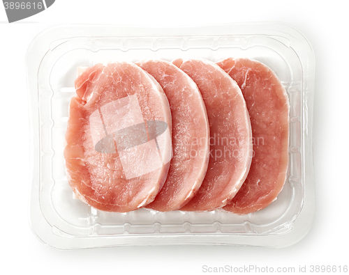 Image of raw pork chops in plastic try