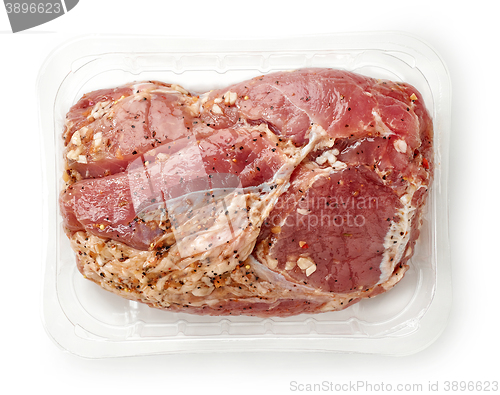 Image of raw pork tenderloin in plastic try