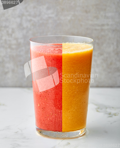 Image of glass of red and yellow smoothie