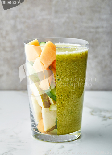 Image of glass of smoothie and fruit pieces