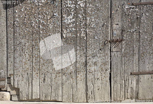 Image of wood with staples and pins