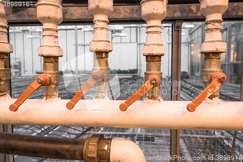 Image of Old pipes with orange handles