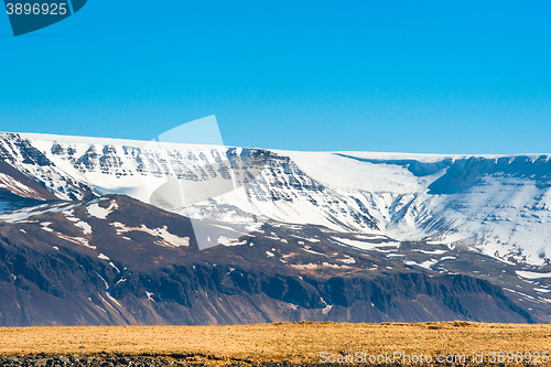 Image of Icelandic scenery with snow on mountains