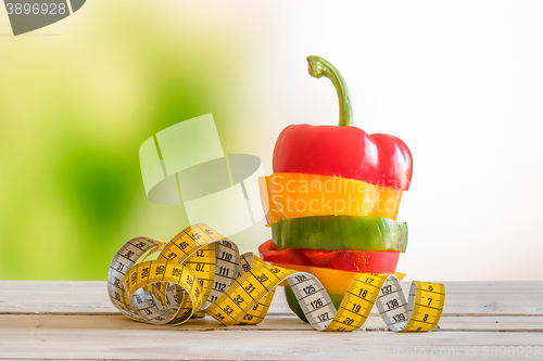 Image of Colorful pepper in a pile on a wooden table