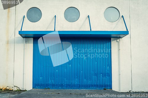 Image of Blue gate on a grungy wall