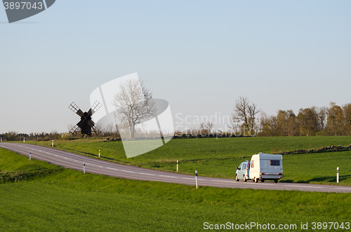 Image of Car with caravan in a green landscape