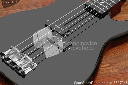 Image of black bass guitar detail