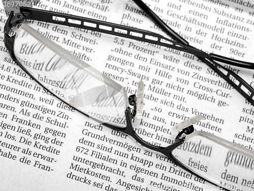 Image of glasses and newspaper