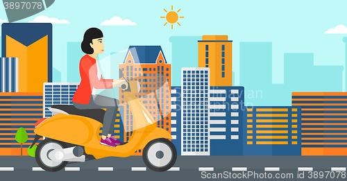 Image of Woman riding scooter.