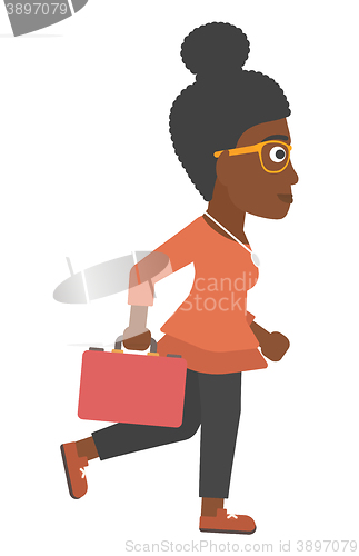 Image of Business woman walking with briefcase.
