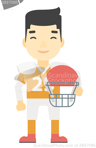 Image of Rugby player with ball and helmet in hands.