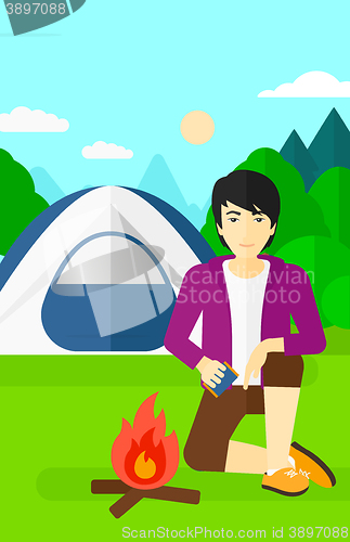 Image of Man kindling fire.