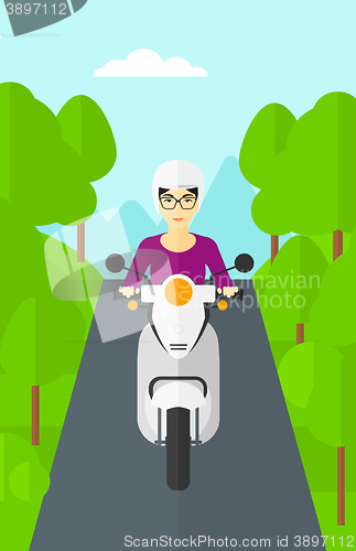 Image of Woman riding scooter.