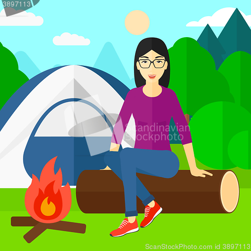 Image of Woman sitting at camp.