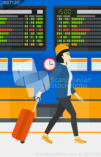 Image of Woman walking with suitcase.