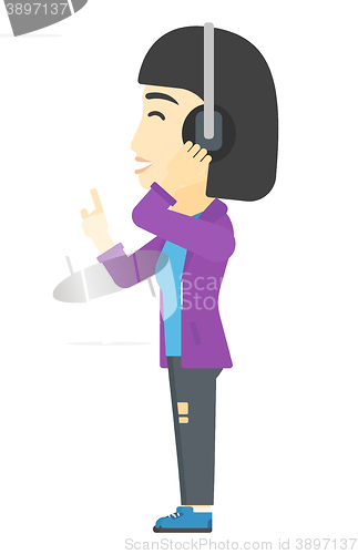 Image of Woman listening music in headphones