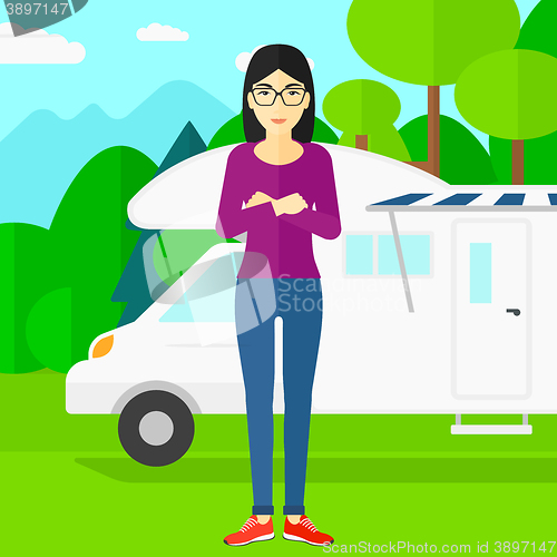 Image of Woman standing in front of motor home.
