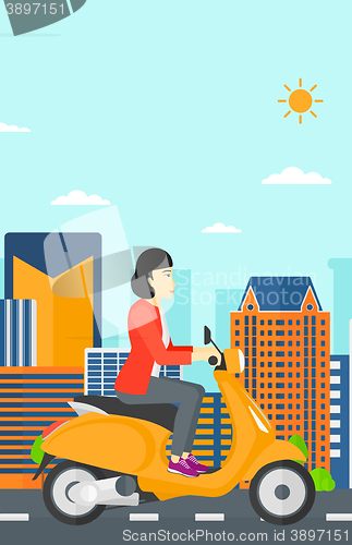 Image of Woman riding scooter.