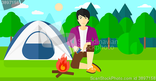 Image of Man kindling fire.