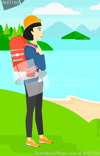 Image of Woman with backpack hiking.