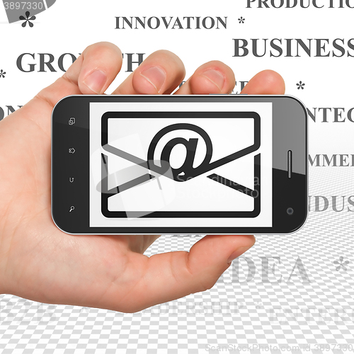 Image of Business concept: Hand Holding Smartphone with Email on display