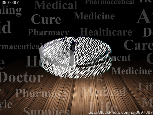 Image of Health concept: Pill in grunge dark room