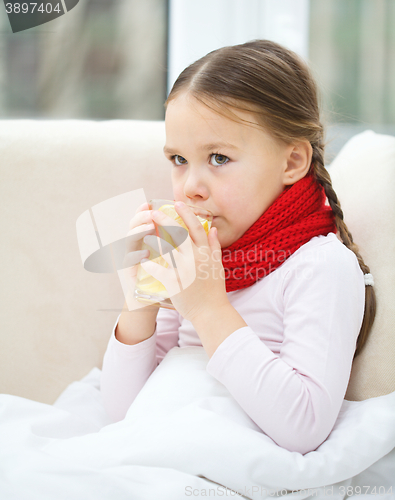 Image of Ill little girl is drinking vitamin cocktail